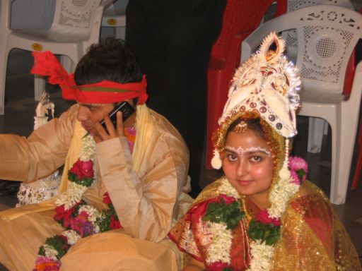 Pradeepto's on the phone during the wedding ceremony